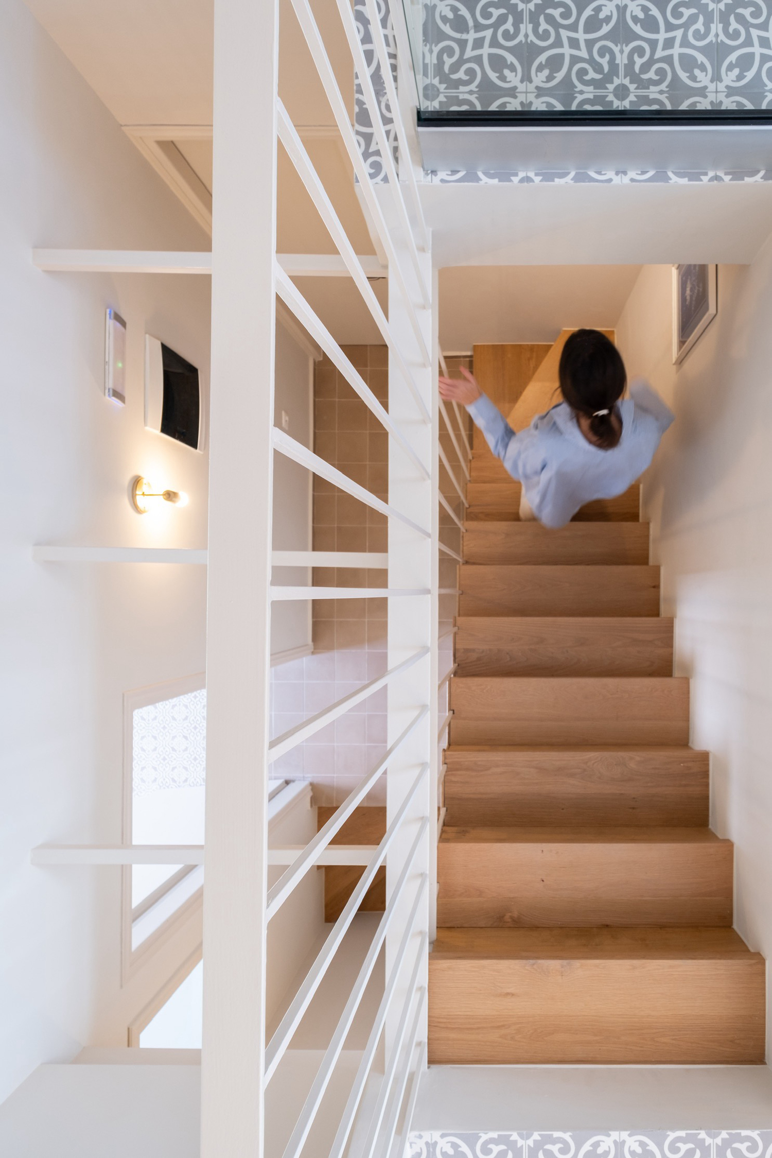 Staircase connecting old stone base with new extension above