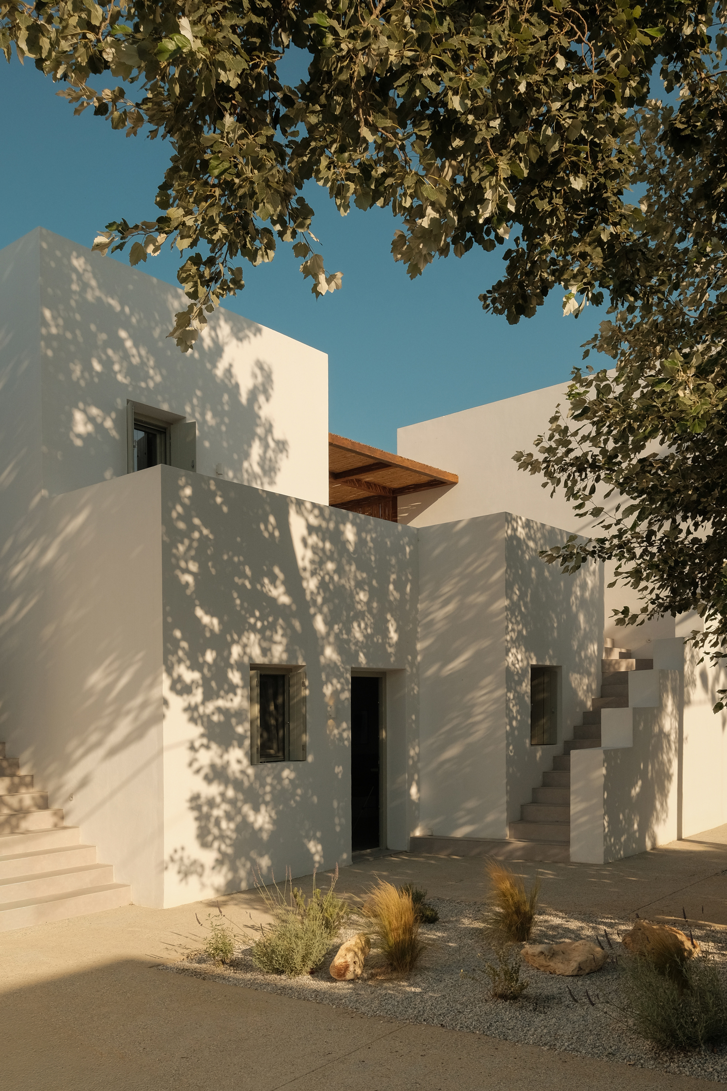 Whitewashed minimalist villa Mazi Paros set along a narrow street in Aliki village