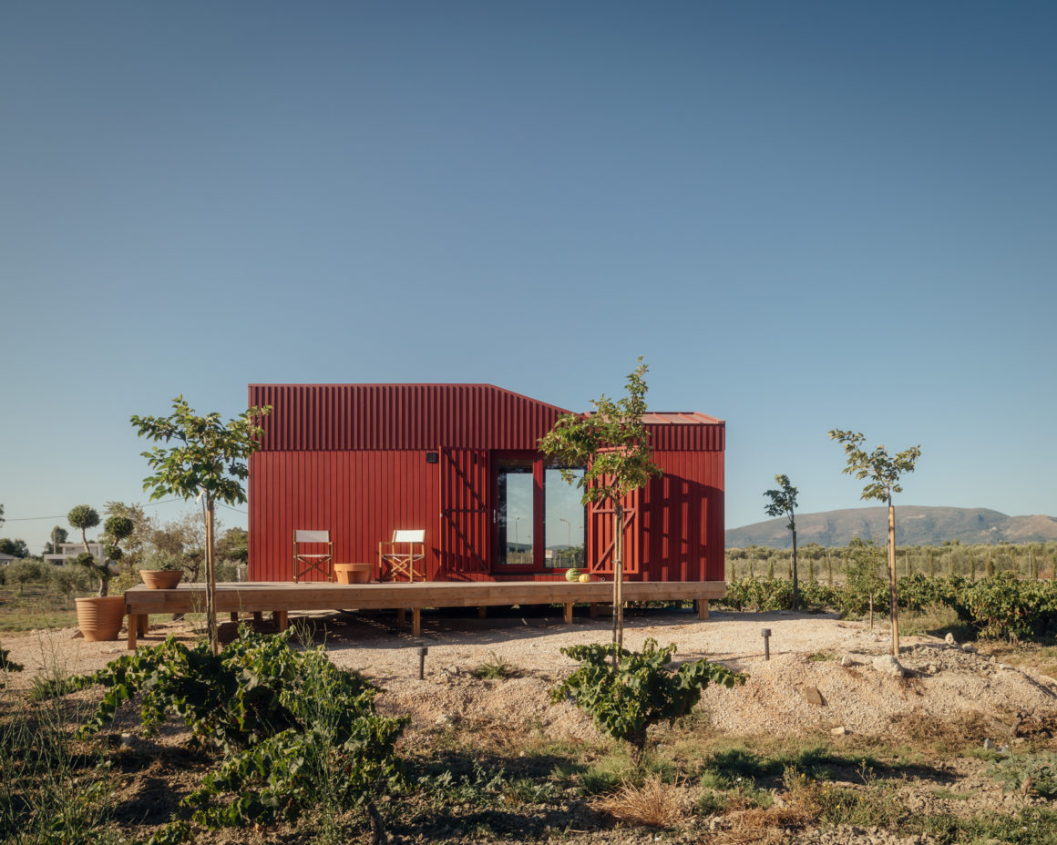 Exterior view of Root Cabin by Kasawoo set among vineyards and olive trees on Zakynthos