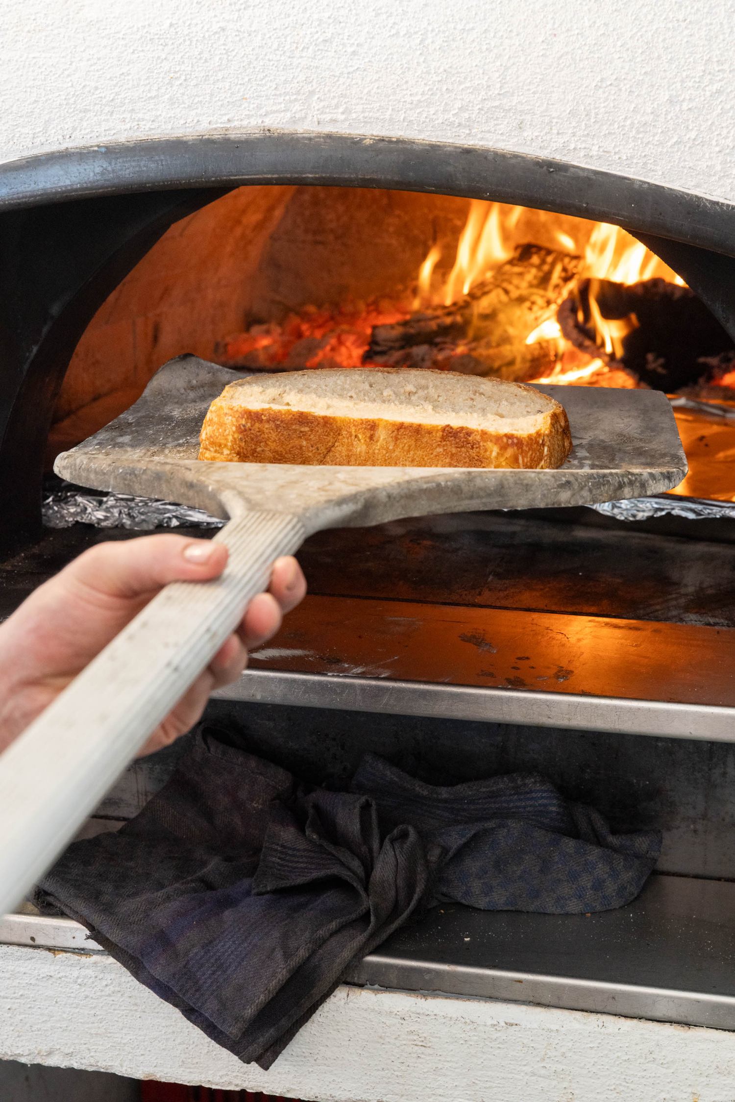 Detail of wood-fired cooking at Plyta’s open kitchen