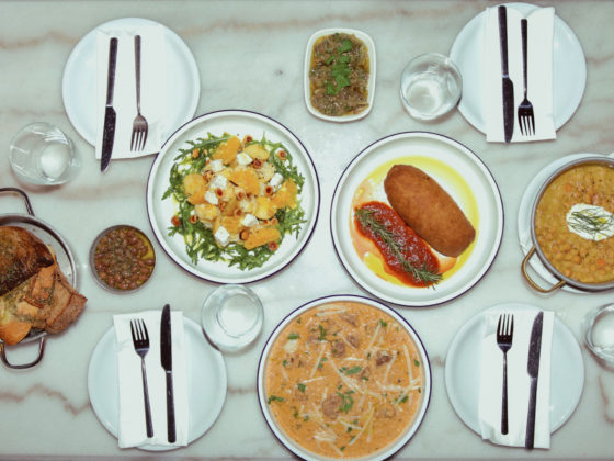 Rustic dining table at Athos featuring shared Greek dishes