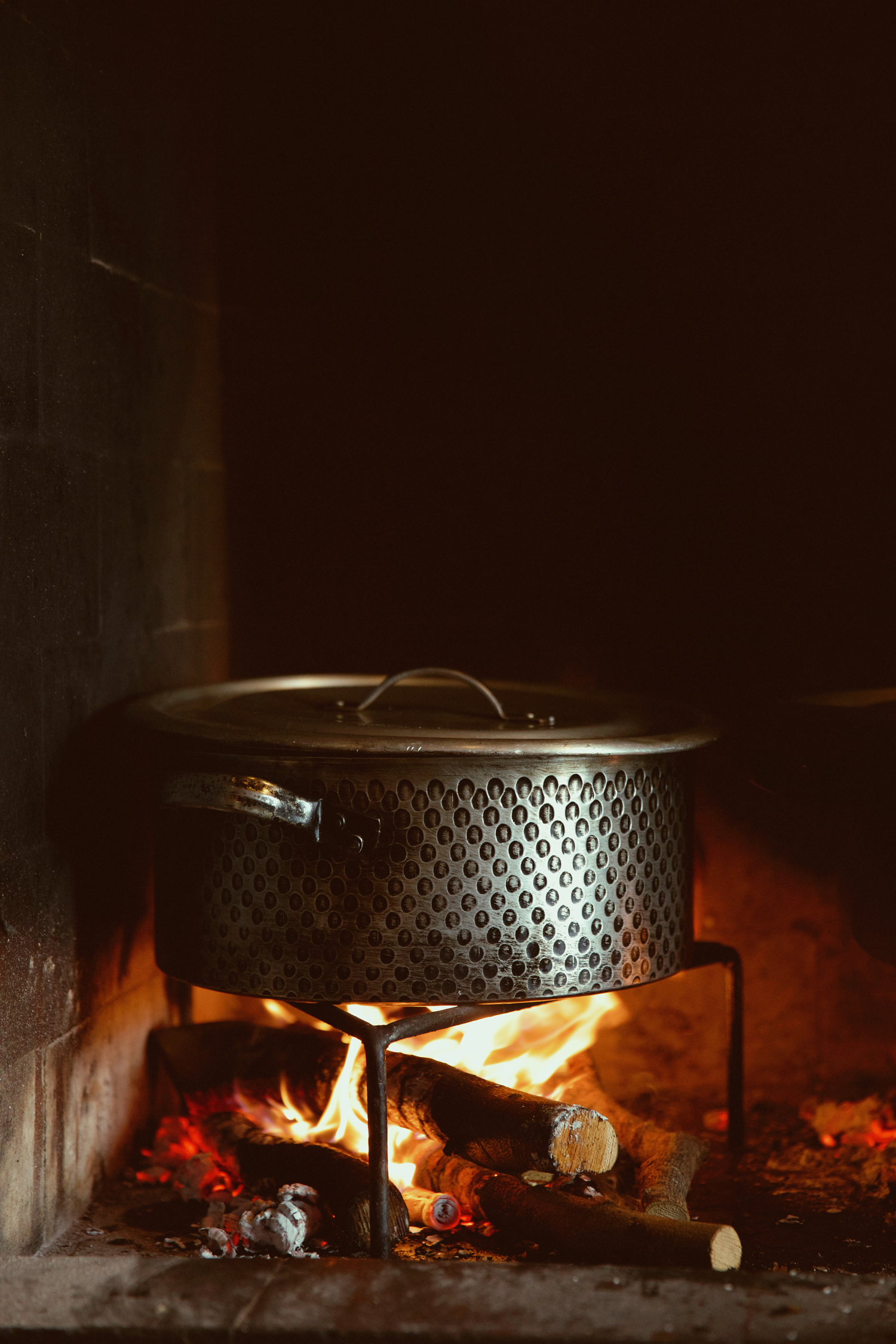 Open-fire cooking technique used for traditional dishes at Athos