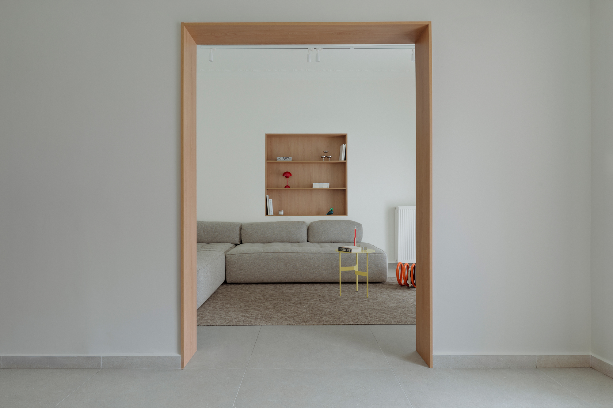 Framed opening between kitchen and living space creating visual connection