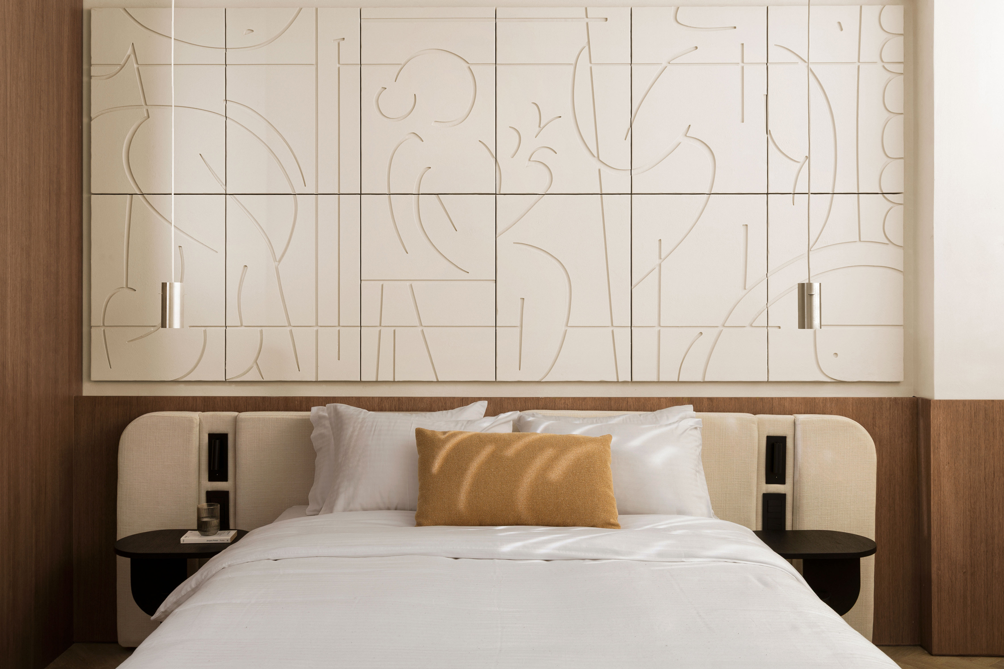 Bedroom with ochre walls and contemporary furnishings overlooking Athens.