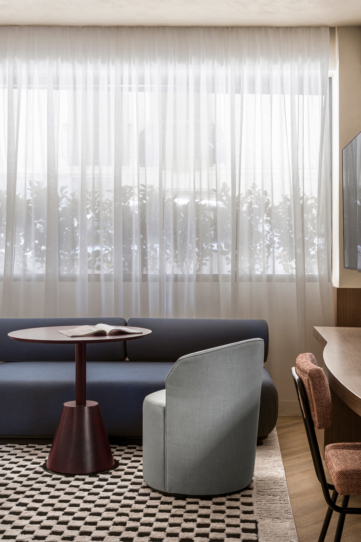 Apartment interior featuring deep blue accents and sculptural architectural elements.