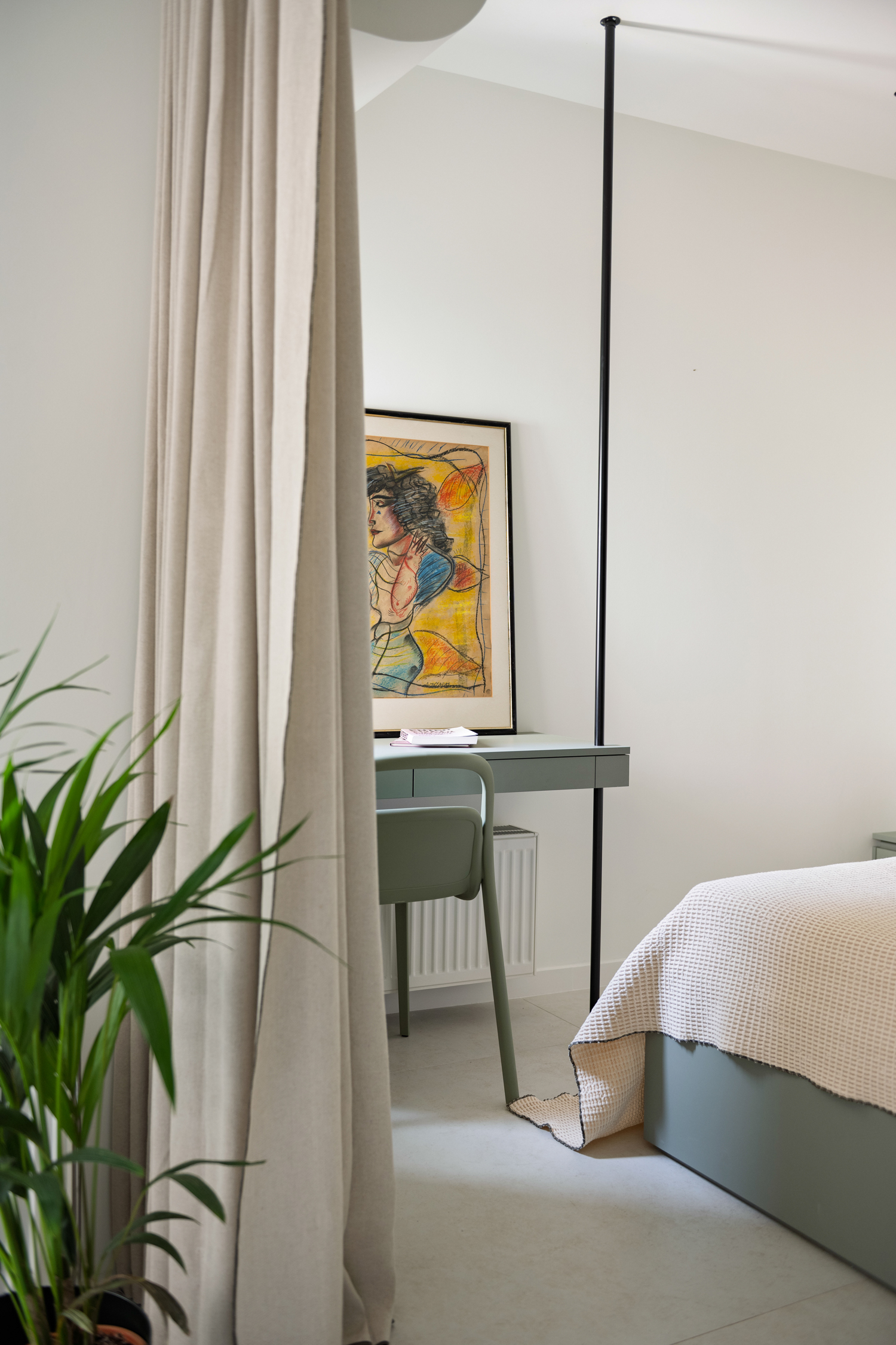 Bedroom with built-in storage, oak flooring and soft natural light.