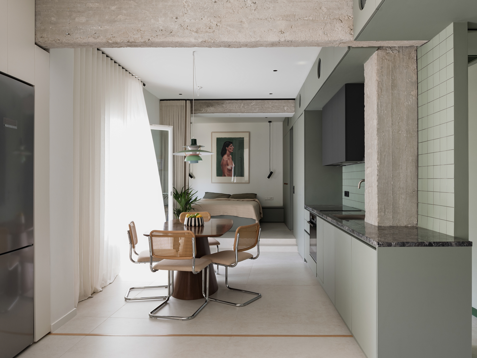 View across the apartment showing the open living spaces arranged along the diagonal layout.
