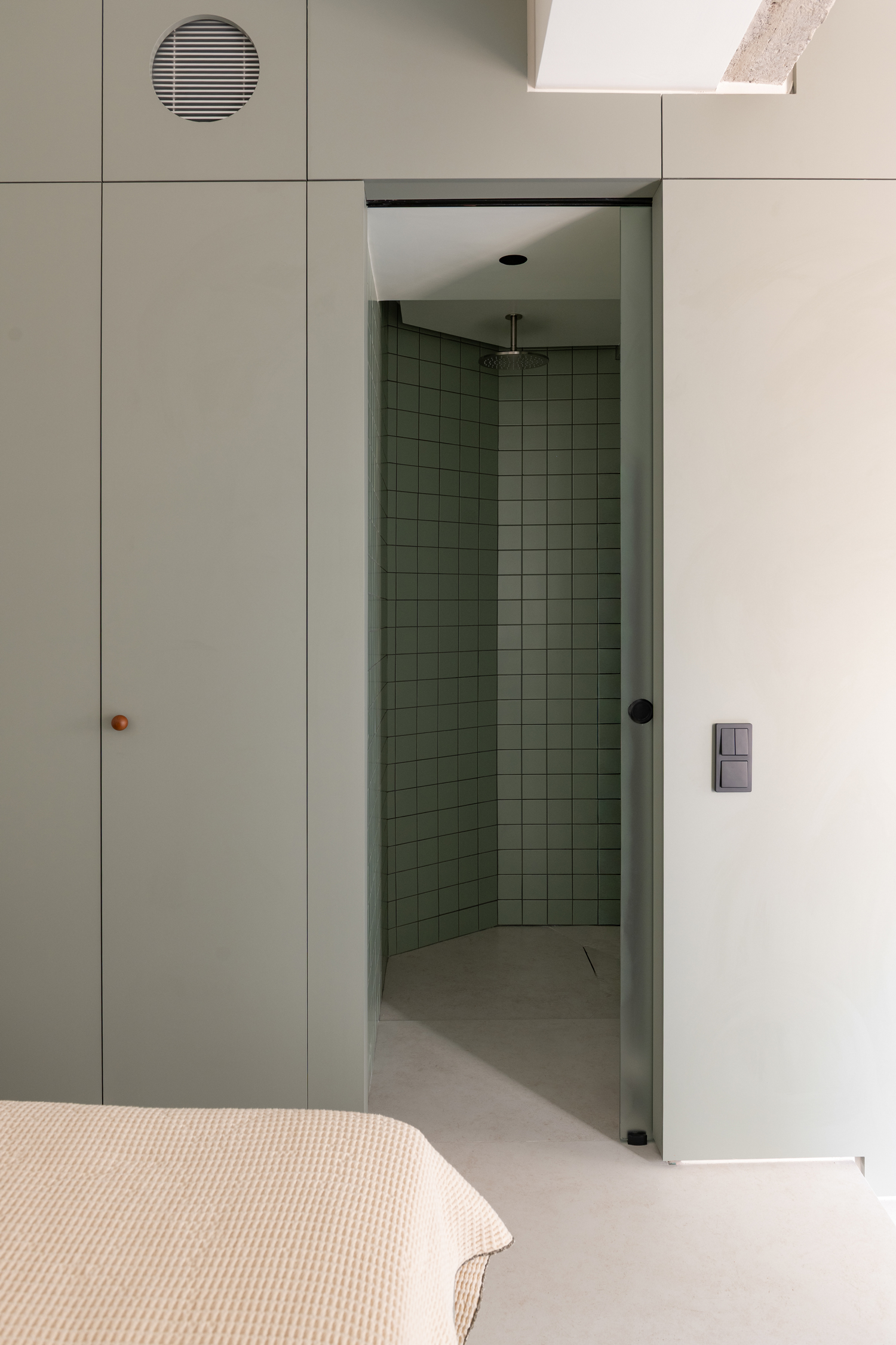 Bathroom featuring a monolithic Tinos marble vanity and minimalist fixtures.