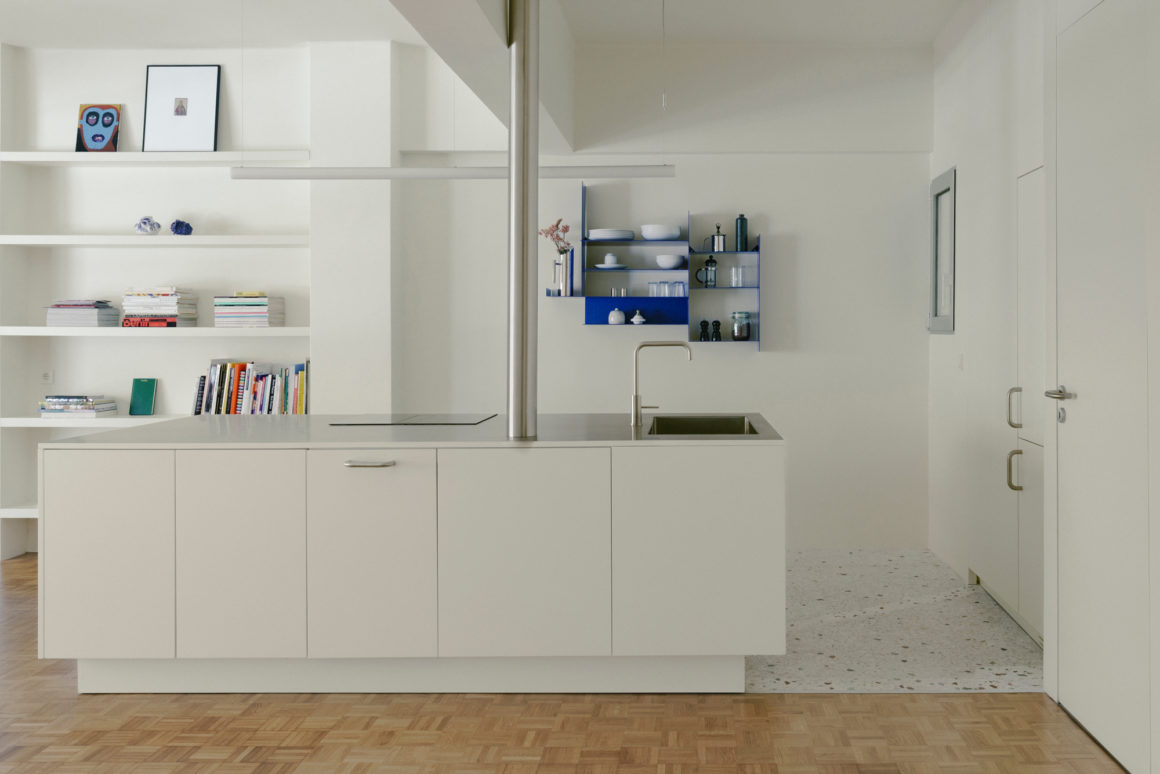 Stainless-steel and timber kitchen island at the centre of a contemporary apartment renovation by Ioanna Vlachaki.