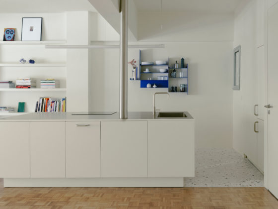 Stainless-steel and timber kitchen island at the centre of a contemporary apartment renovation by Ioanna Vlachaki.
