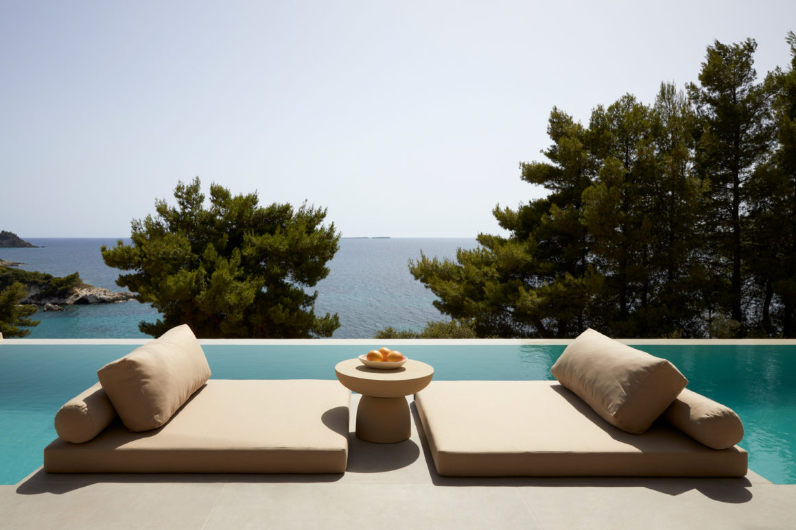 Exterior view of The Wildt, a collection of stone-clad holiday villas by LArchitects overlooking the Ionian Sea in Kefalonia.