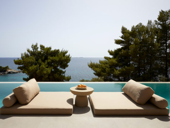 Exterior view of The Wildt, a collection of stone-clad holiday villas by LArchitects overlooking the Ionian Sea in Kefalonia.
